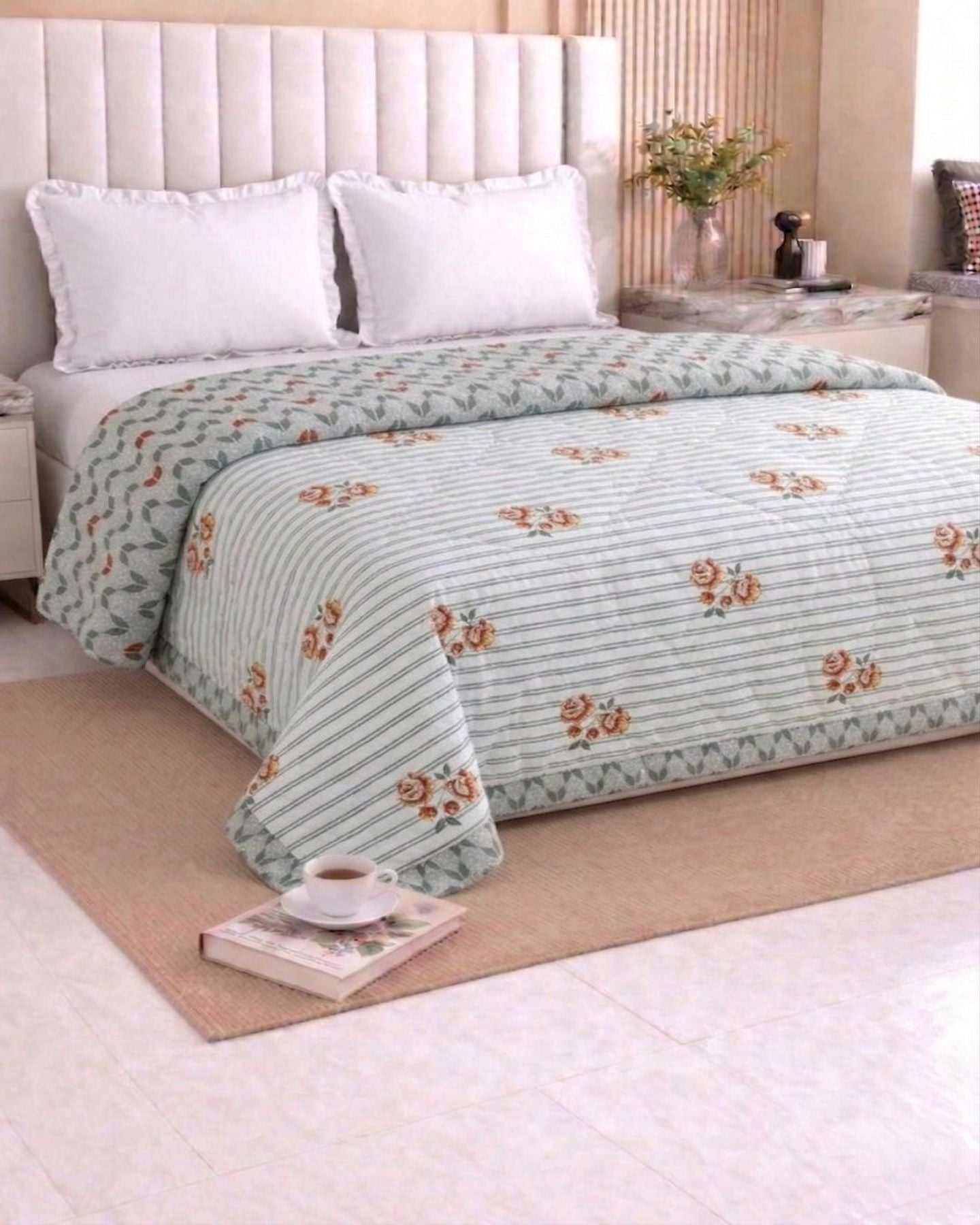 Green and white floral dohar on a bed